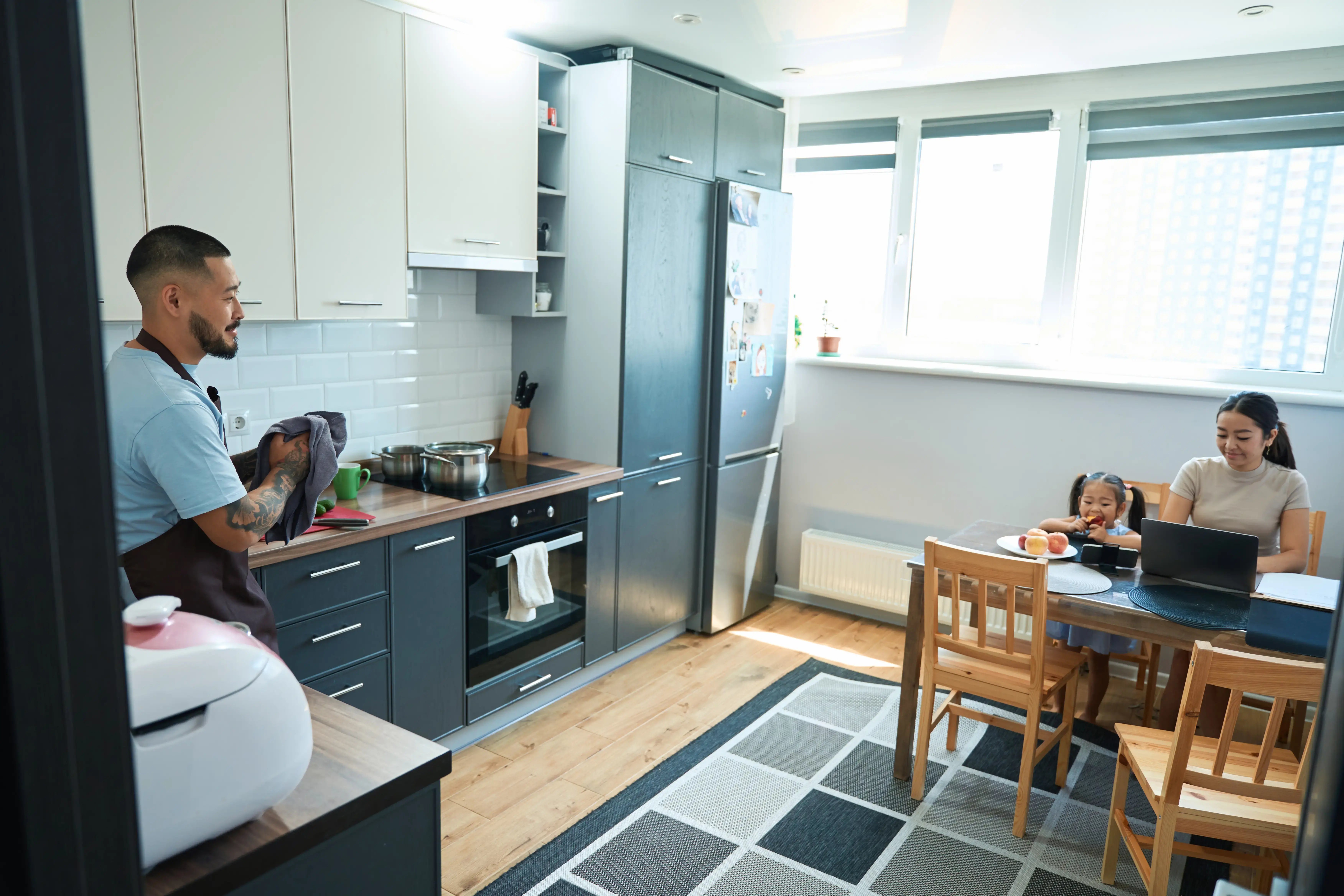 smiling-man-with-kitchen-towel-in-his-hands-stands-2024-10-18-22-04-49-utc